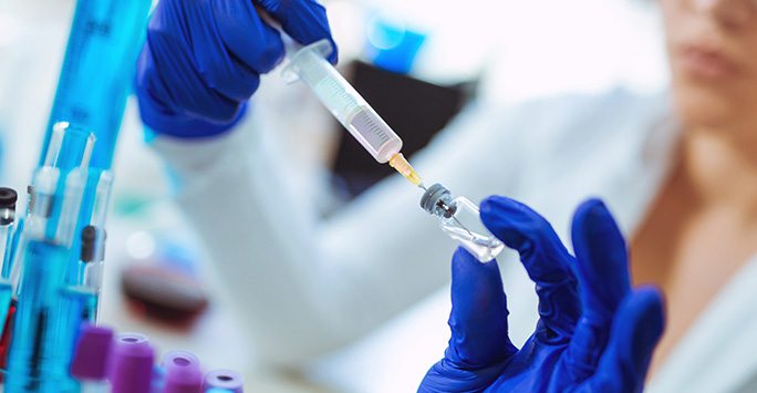 Scientist in lab working with a vaccine