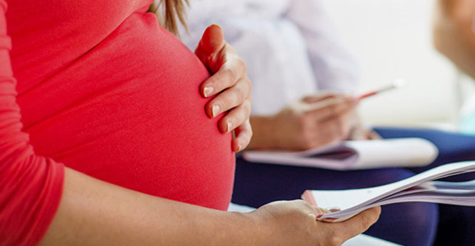 Pregnant woman reading some information