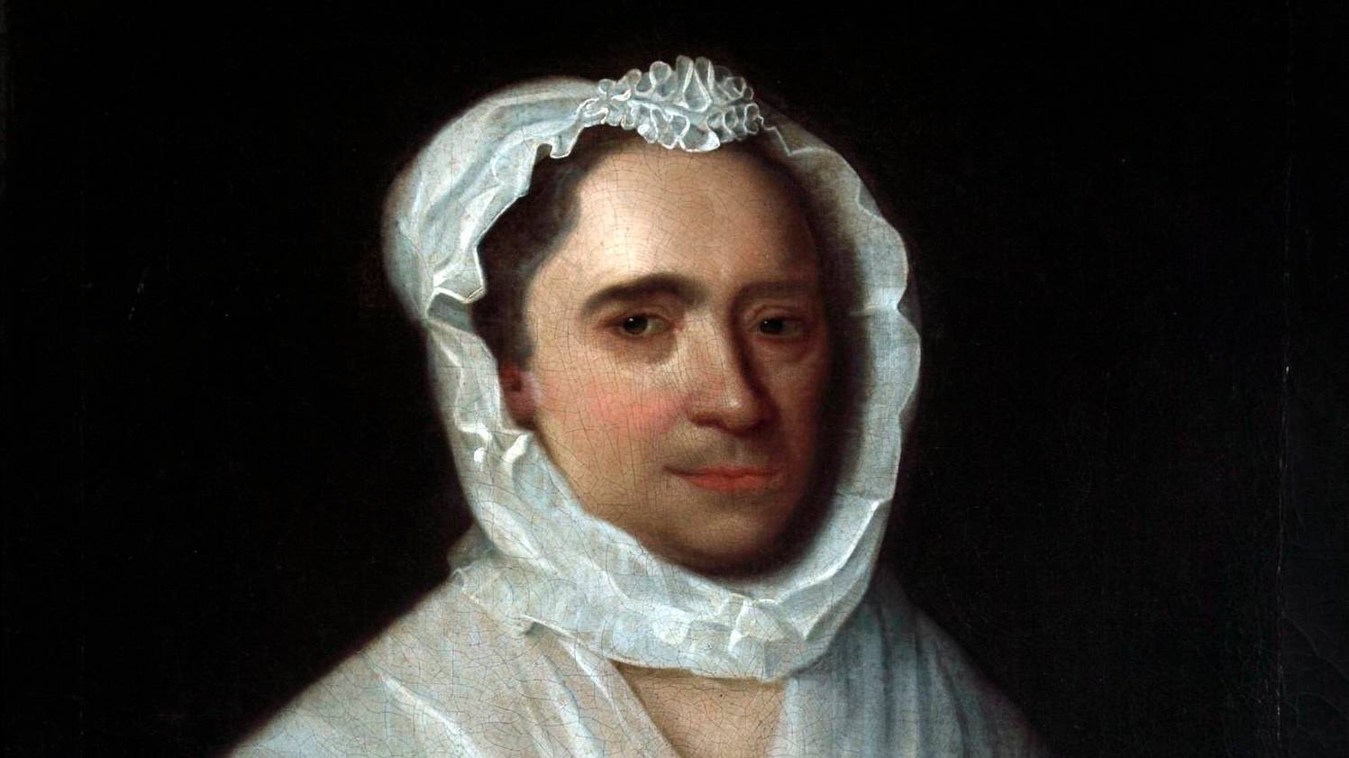 Detail of a portrait of a woman wearing a blue silk dress holding a jasmine flower with a white bonnet and collar. She holds a jasmine flower in her right hand. The lower half of her face has a five o'clock shadow. 