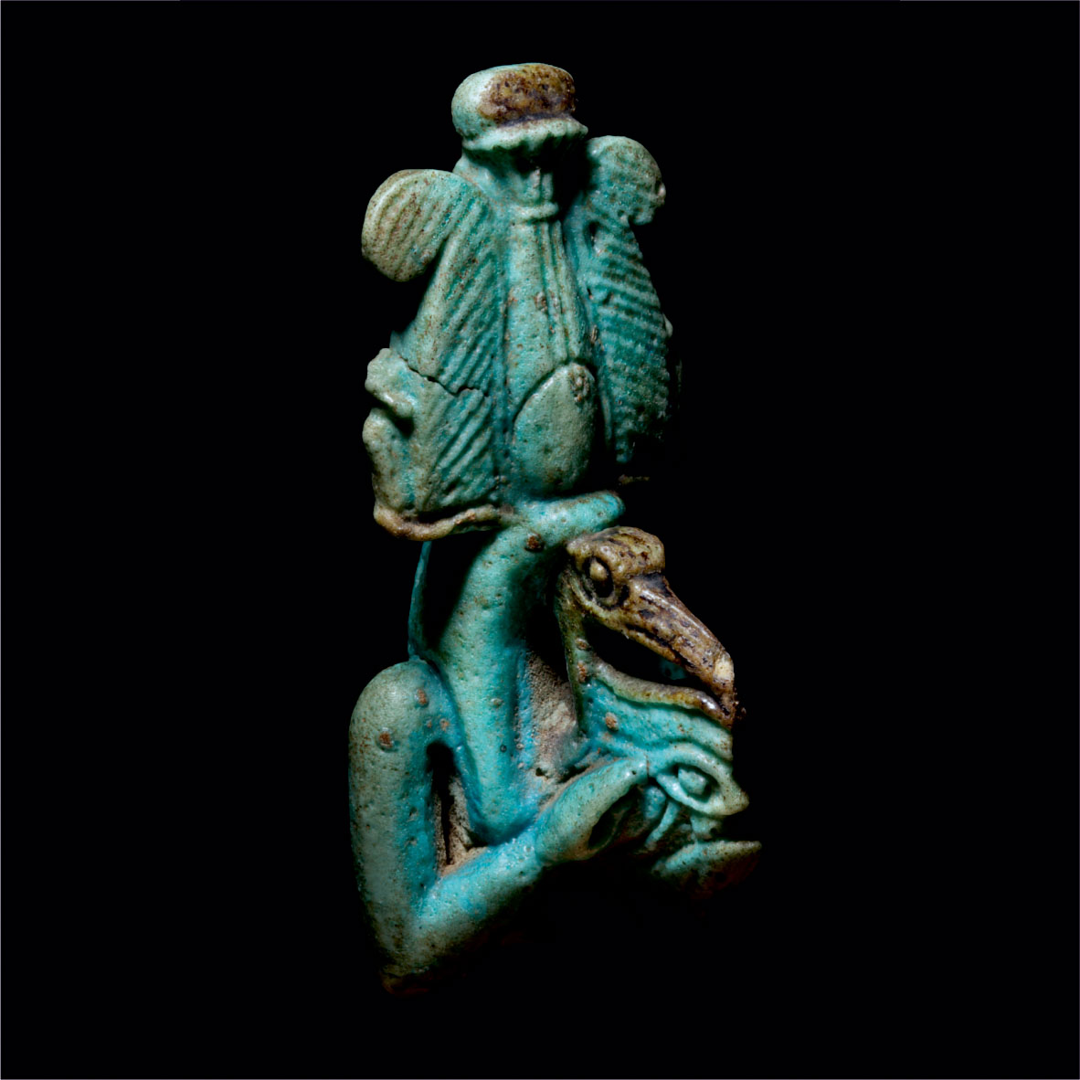 Bright blue amulet of an Ibis-headed man, wearing a crown made of ostrich feathers