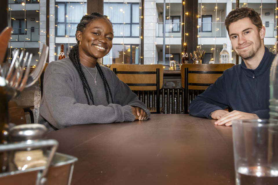 Two students sitting  in a bar close to the city campus