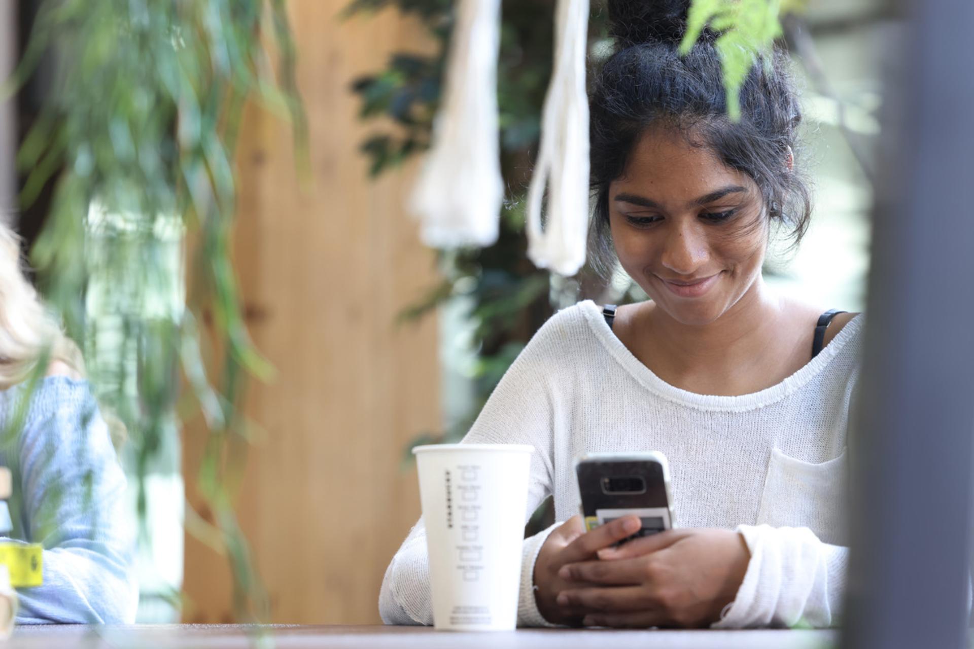 A student using a smartphone.