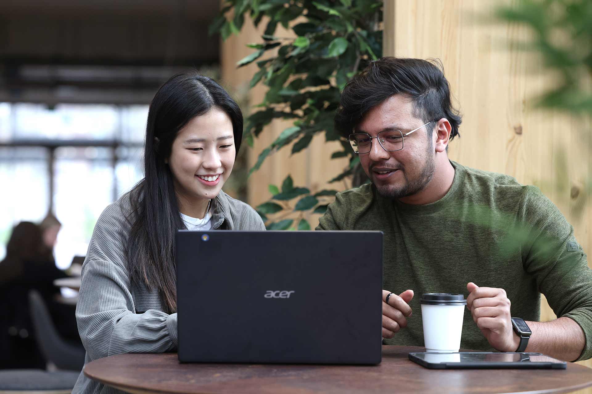 Two students working on a laptop.