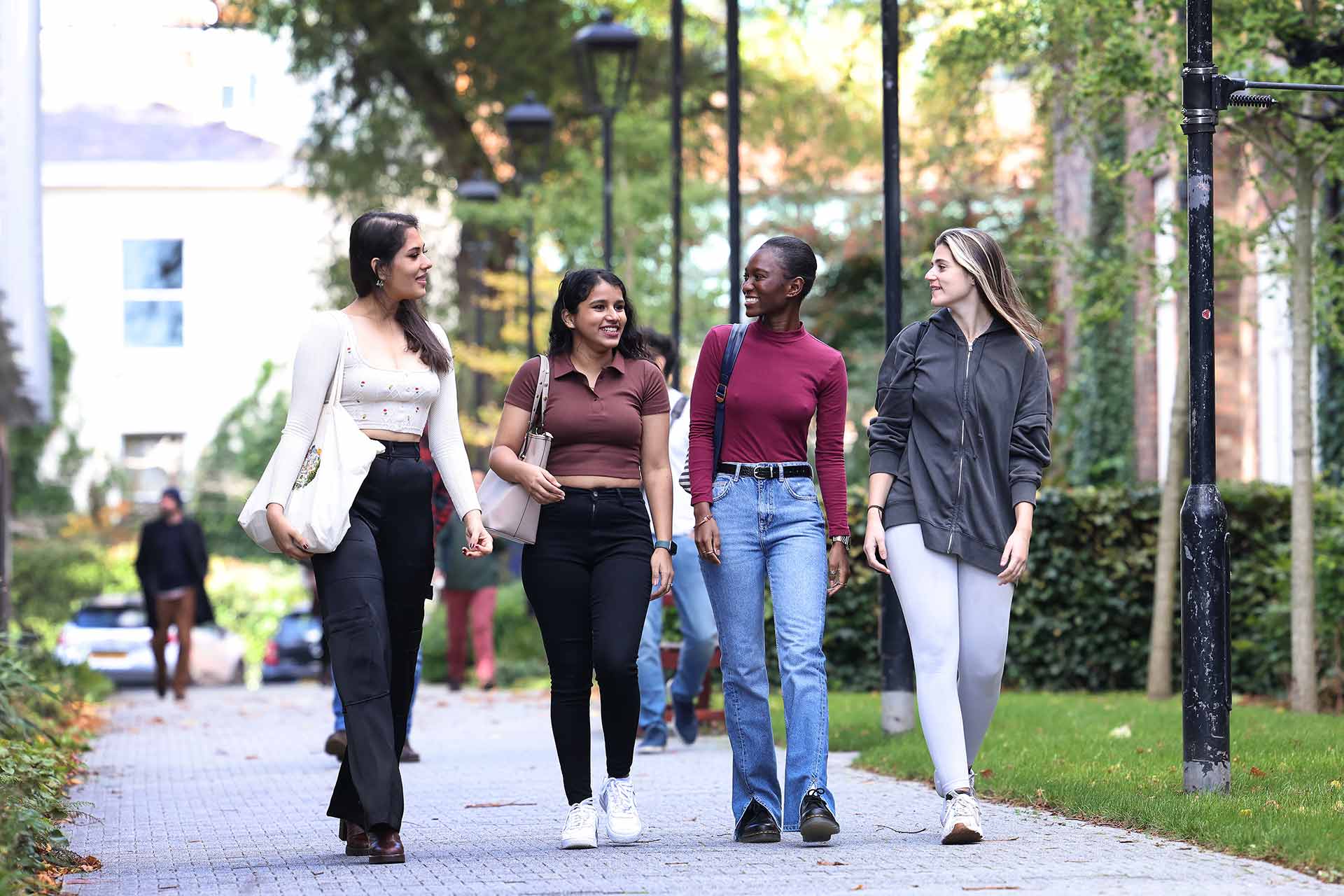Four students walking on campus