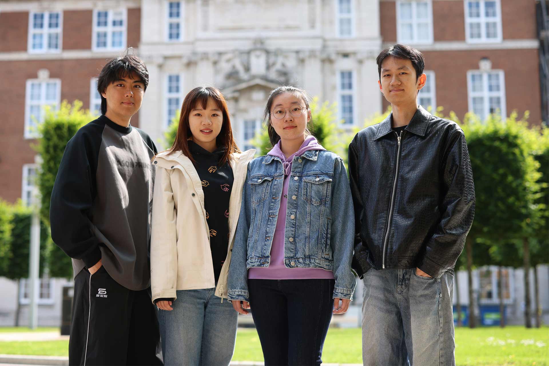 Four XJTLU student ambassadors standing in The Quadrangle