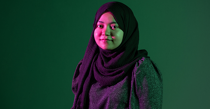 Colourful photograph portrait of a student against a green background