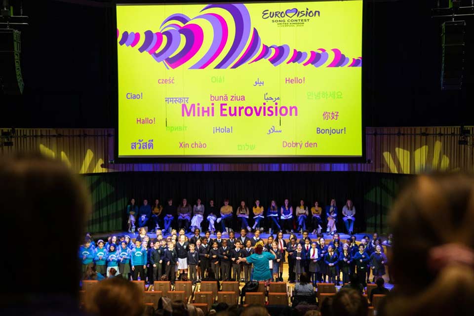 Children singing on stage at the Mini Eurovision event