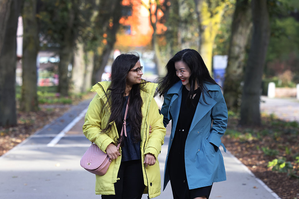 2 female students walking on campus