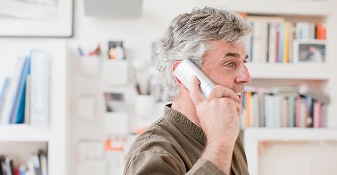 Older man talking on the telephone