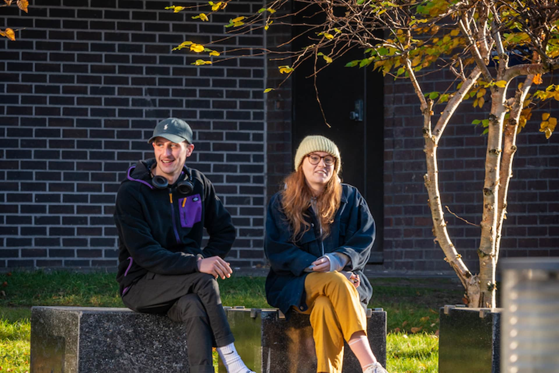 Students sitting on bench on campus