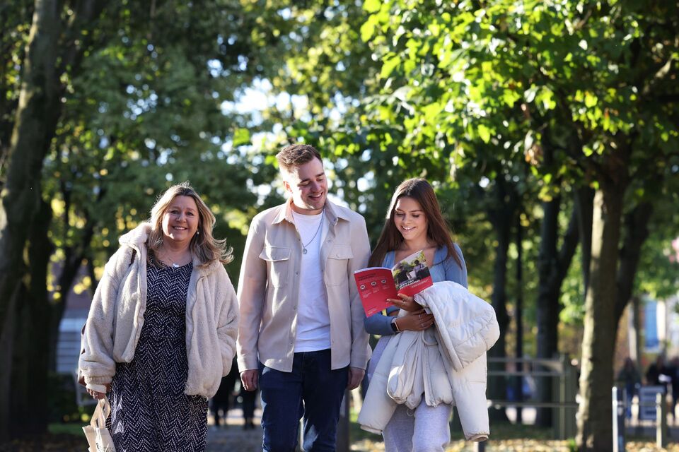 three students walking through the park