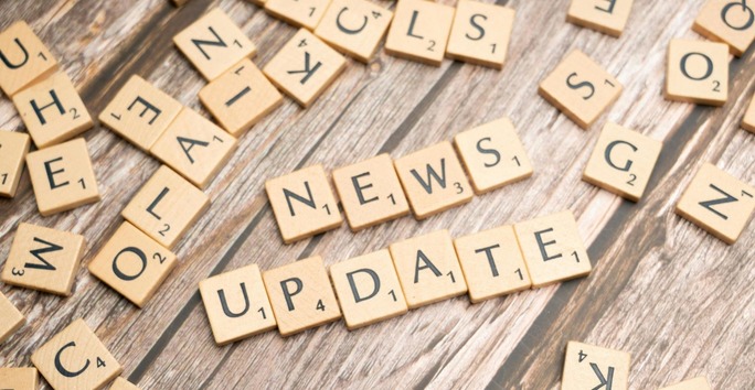 alphabetical wooden blocks spelling out news update on wooden background