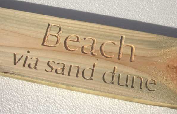 A wooden sign with the text 
