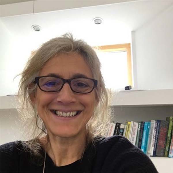 Irena Bauman photographed in front of a book shelf