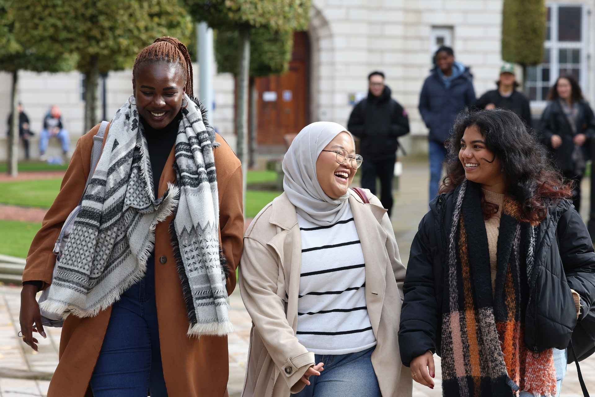 A diverse group of international students at the University of Liverpool, engaging in a welcoming and inclusive campus environment.