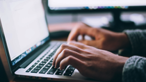 Person Typing on Laptop
