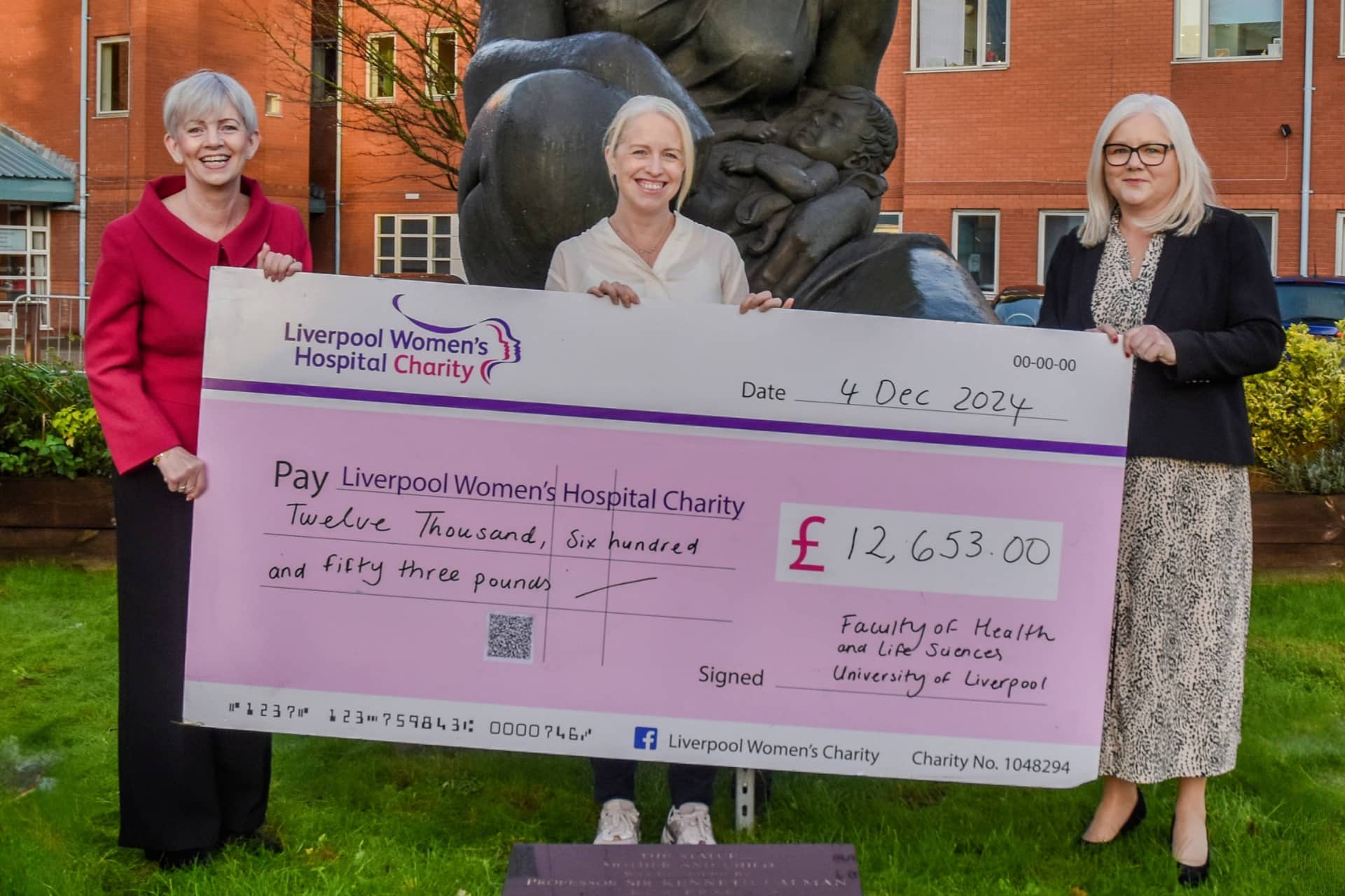 Louise Kenny and LWH representatives hold oversized cheque
