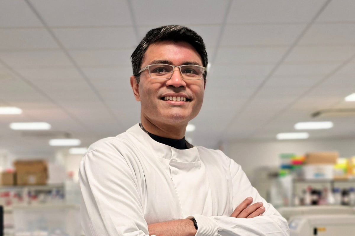 Mr Rajarshi Mukherjee in the lab, dressed in a white lab coat