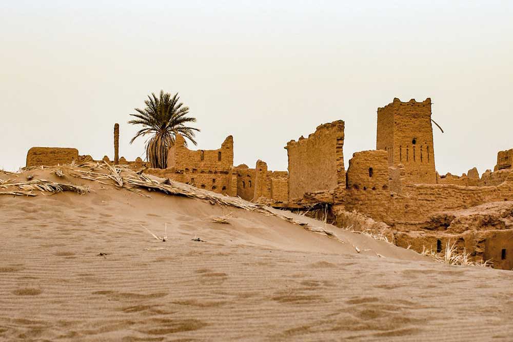 A sandstone building in a desert setting