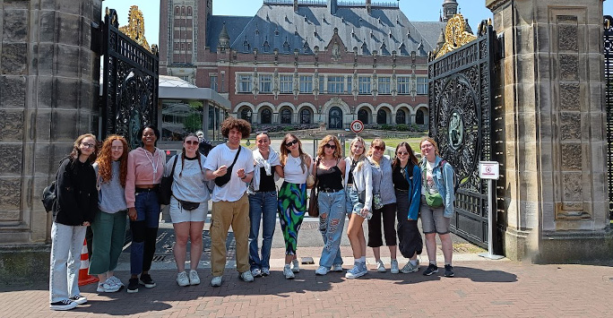 A group of students stand outside the Peace Palace Visitors Centre at The Hague.