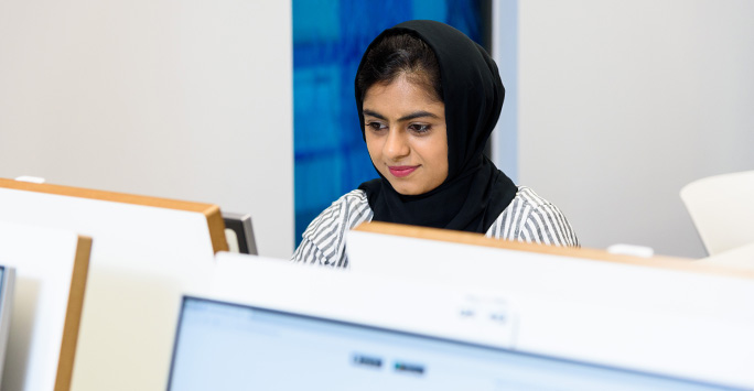 A student sitting at computer.