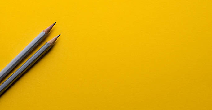 Pencil on yellow background.