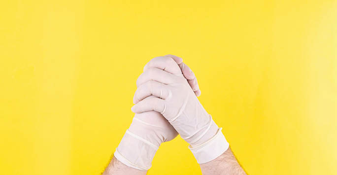 Someone wearing surgical gloves.