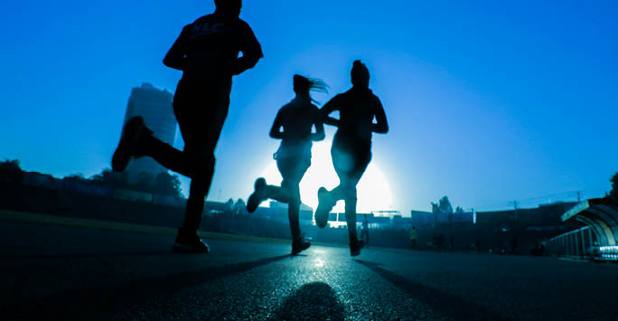 Three runners at twilight.