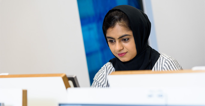 A student working at a computer in the Law Clinic
