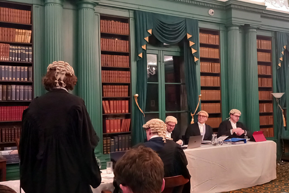 A mock courtroom with participants dressed in court gowns and wigs,