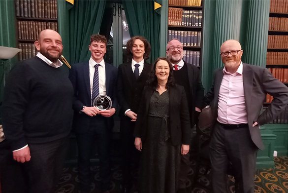 Students Danny and Oliver stand with staff from the Liverpool Law School.