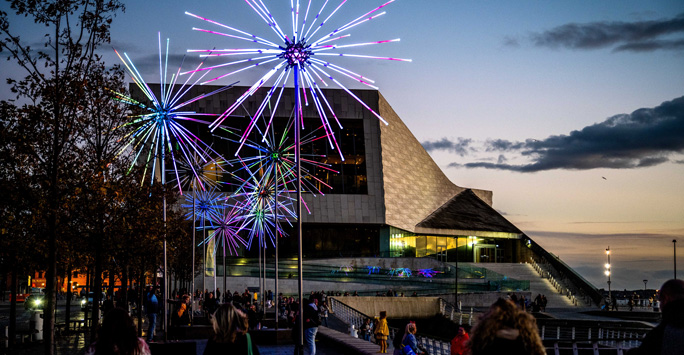 Liverpool Museum at sunset.  In front of the rectangular shaped museum building are light installations.