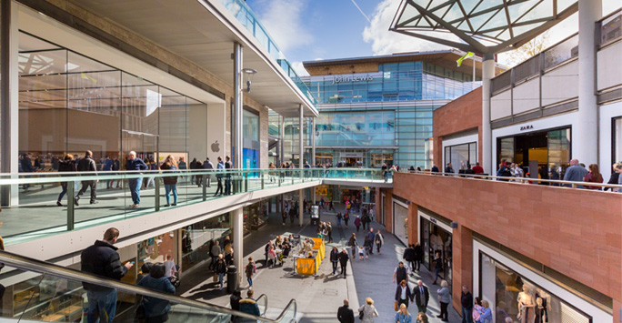 Liverpool One shopping area. Three floors of shops and restaurants filled with people.