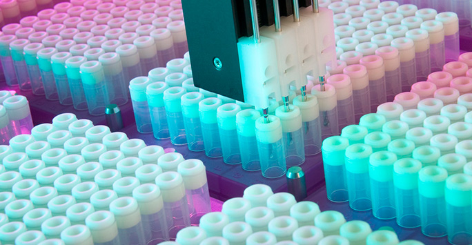 An automated system handling multiple vials in a laboratory setting.