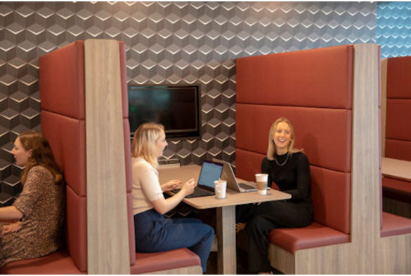 Natalie Mann sitting in a booth with anoher women