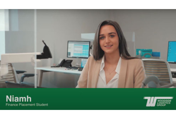 Niamh McGurn at work with green footer of her name, title and company