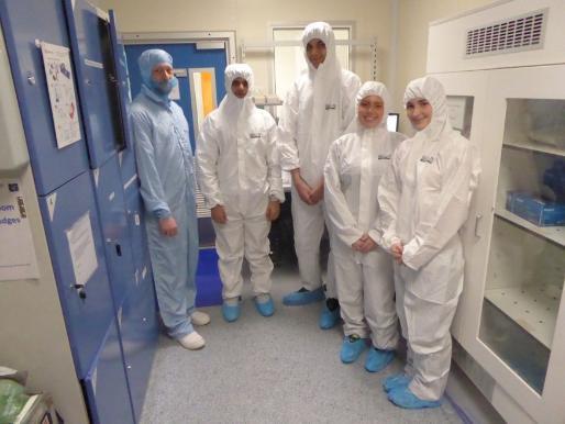 A group of students in protective gear stands together in a room, emphasizing safety and preparedness.