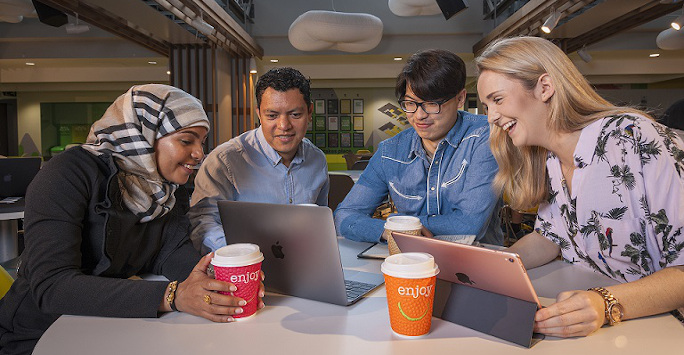 Postgraduate students studying and chatting