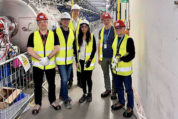 Group of people in high visibility vests and safety helmets.