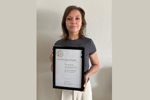 A person holding a certificate.