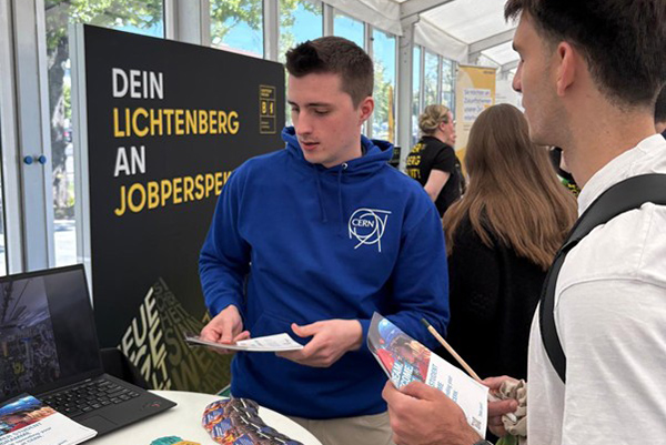 A person explaining something at an exhibition.
