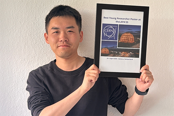 A person hoding a picture frame of an award.