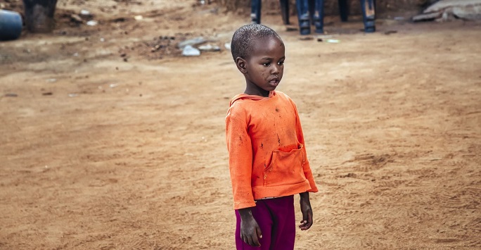 Photograph of an African child in a bare yard