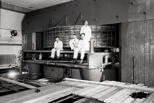 Workers at the University of Liverpool’s Chadwick Lab sit on the synchrocyclotron’s massive single magnet