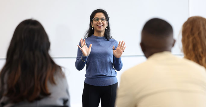 A student standing at the front of a classroom