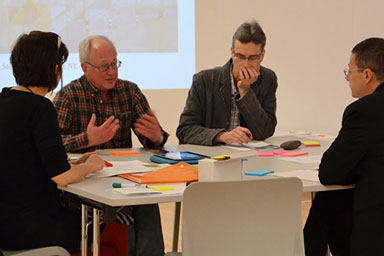 People sitting around a desk talking