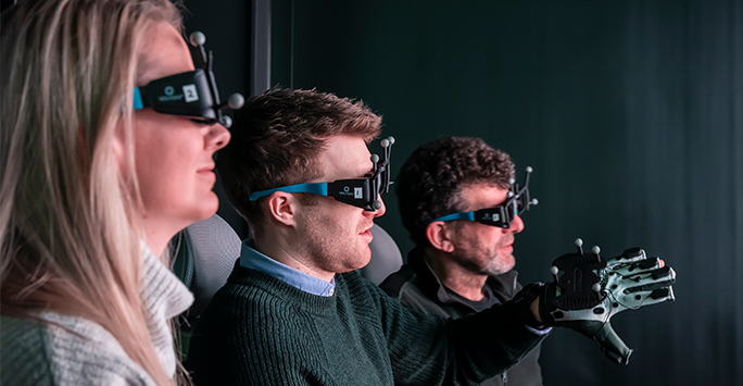 3 people using virtual reality headsets