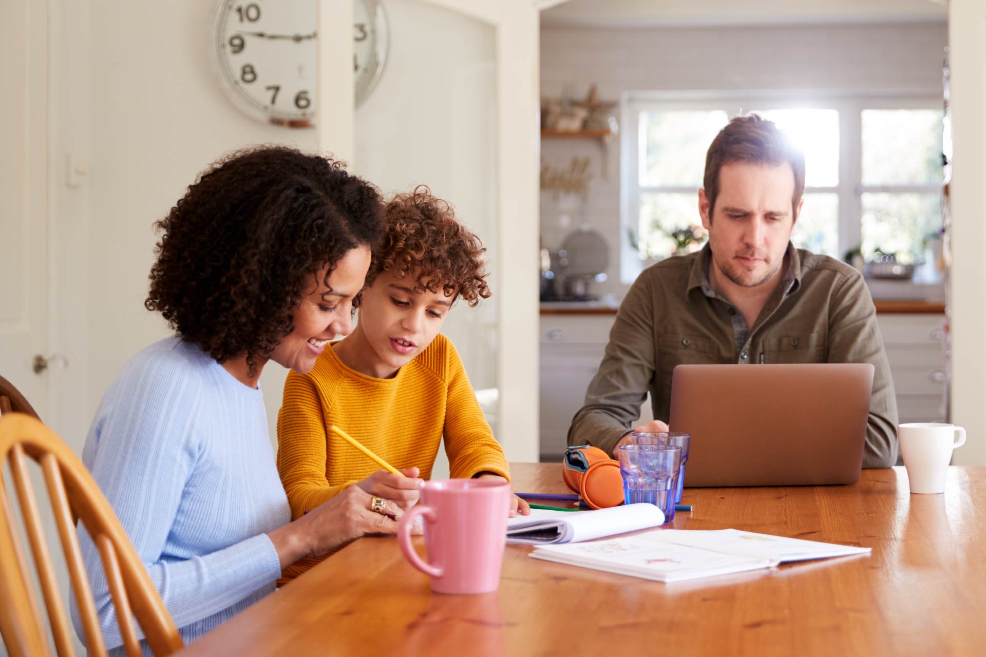 Mother entertains daughter while father works, showing the persistence of traditional work-family decision making among working couples