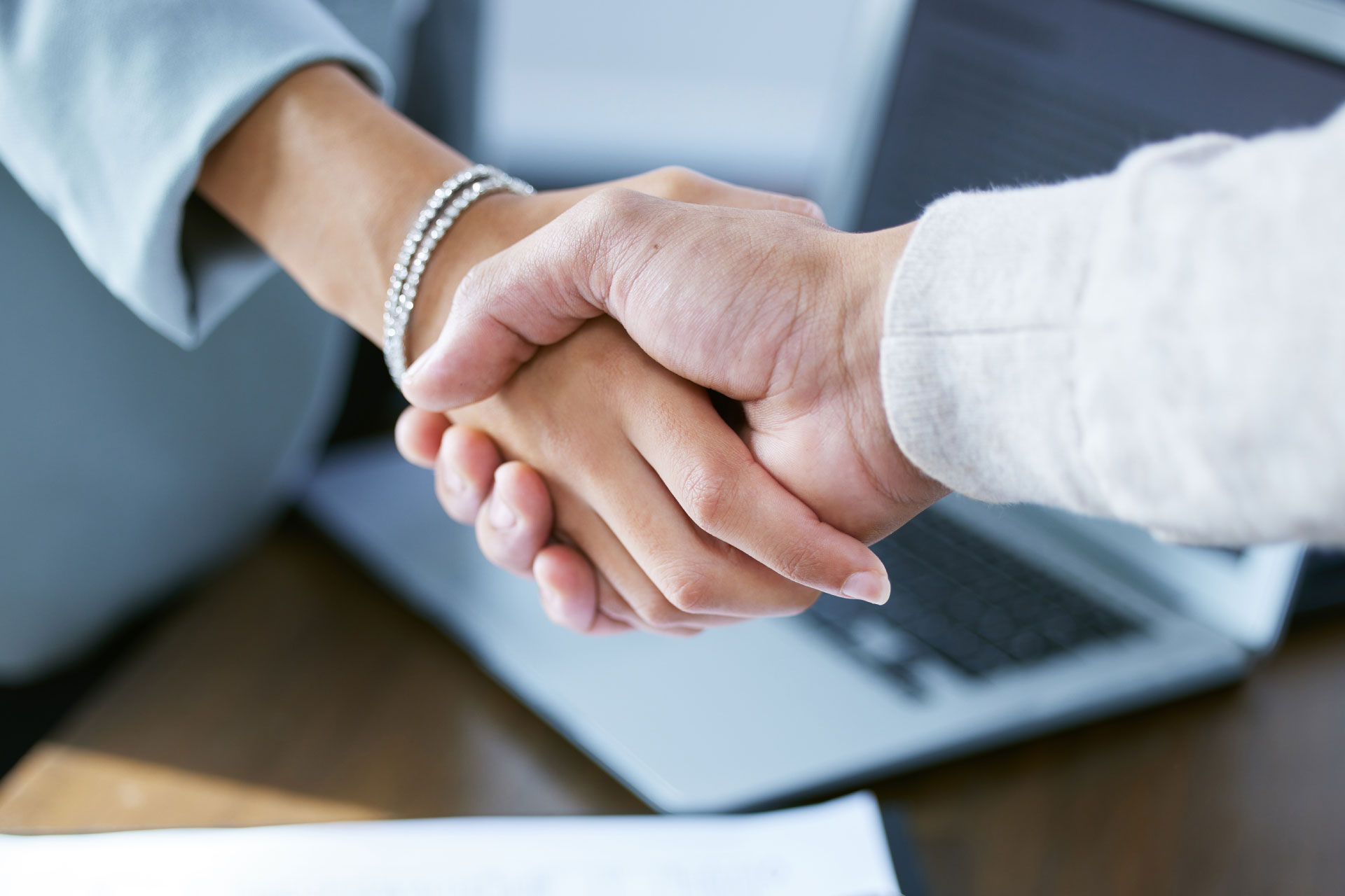 Male and female businesspeople shake hands