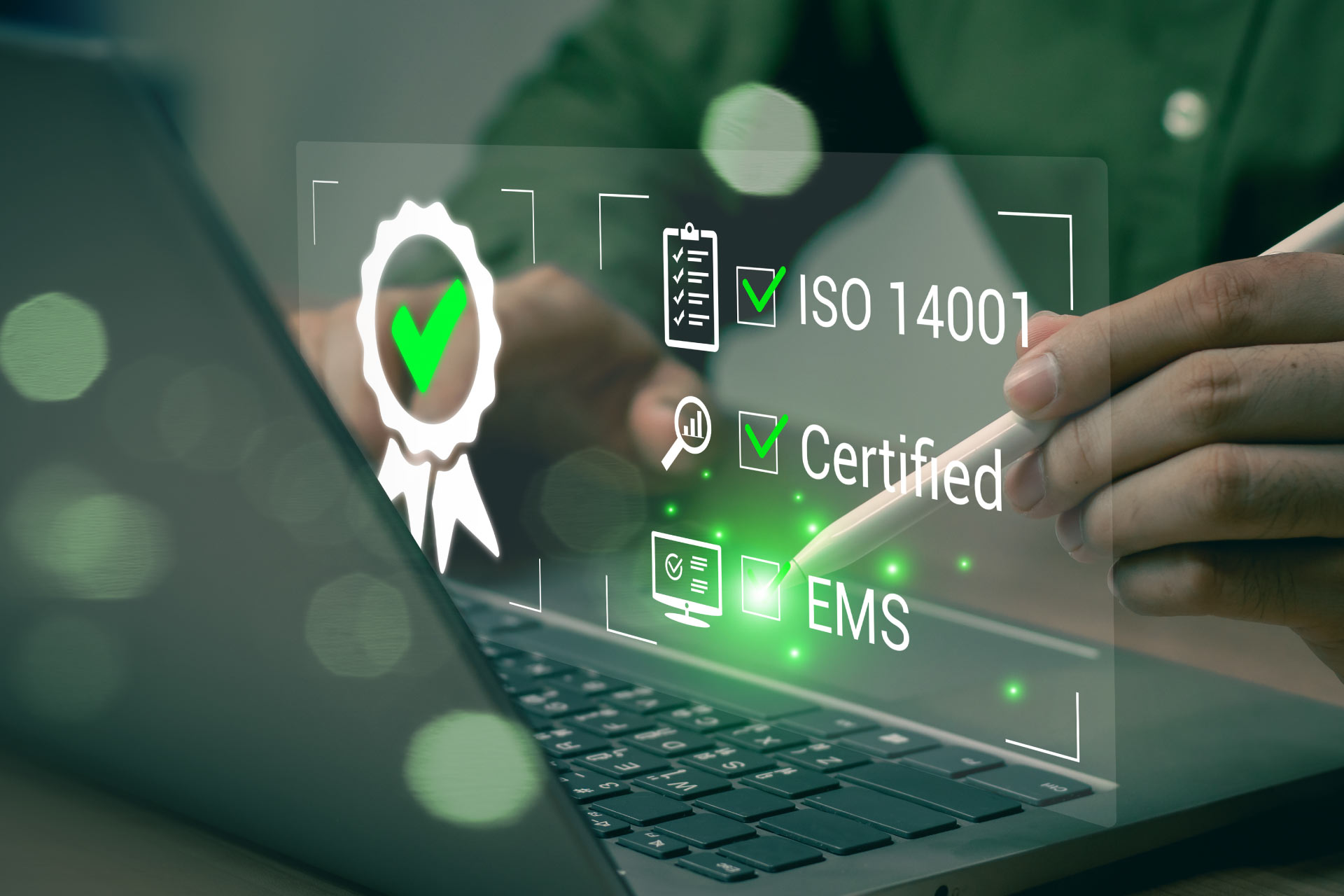 Person working on ISO 14001 certification on a computer.